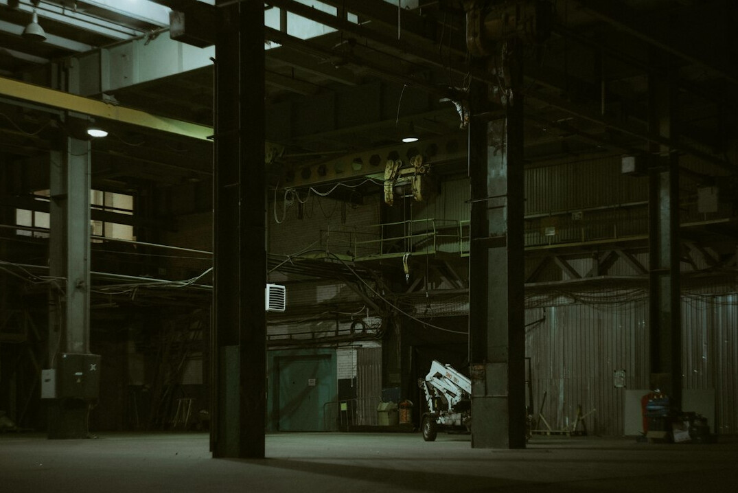 detective investigating warehouse at night