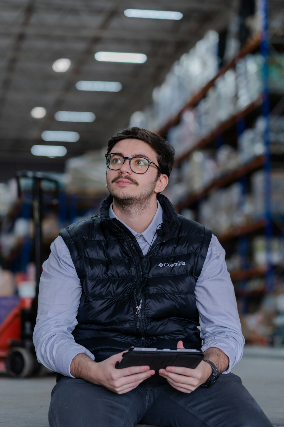 security guard checking warehouse shelves at night